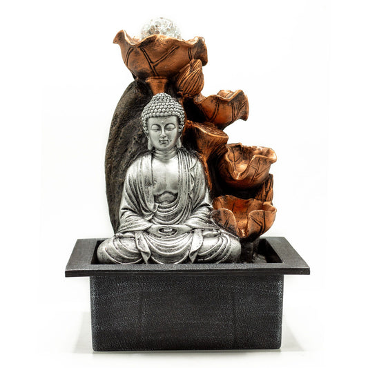 Buddha statue in a decorative water fountain with rocks on a white background