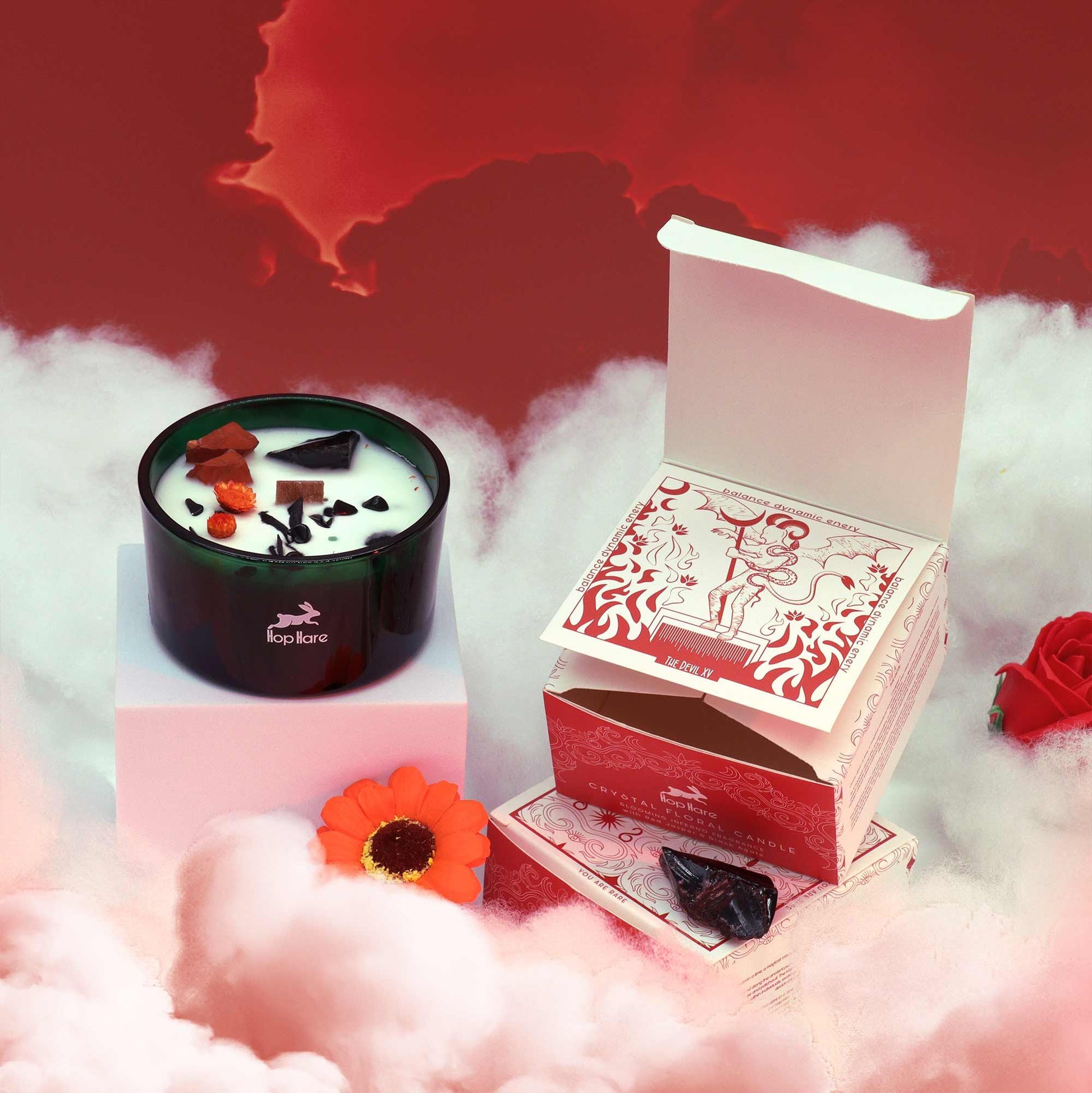 Candle with decorative elements on a red and white background