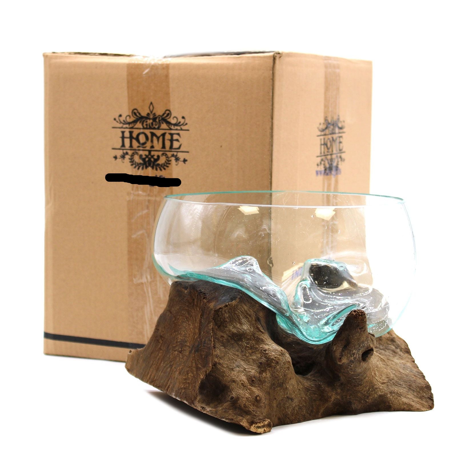 Glass bowl with wavy design on a wooden base in front of a cardboard box labeled 'HOME'.